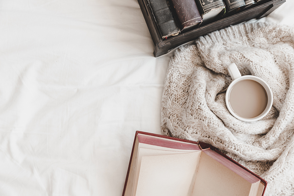 otebook box with books near hot drink plaid