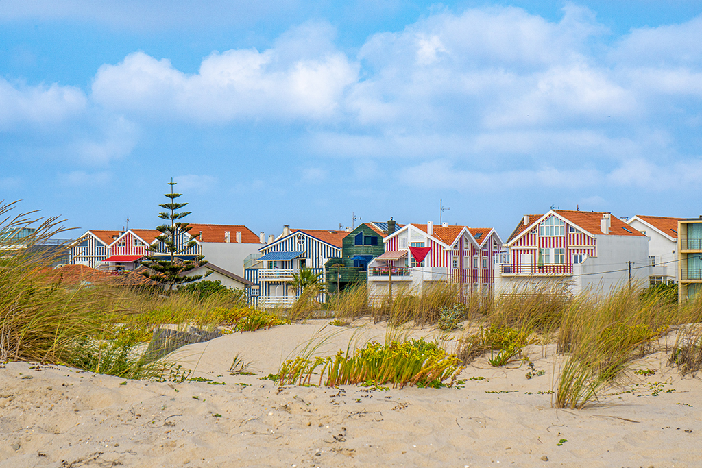 colorful houses costa nova aveiro from salt sand sunny day beautiful blue sky